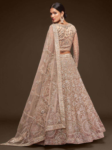 Ravishing Beige Embroidered Soft Net Ceremony Wear Lehenga Choli